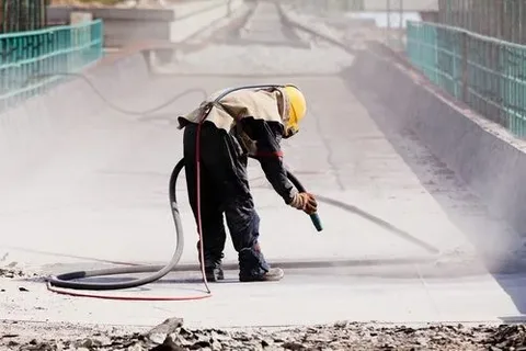 Industrial vacuum cleaner placed on a dusty floor during a commercial post construction cleaning job